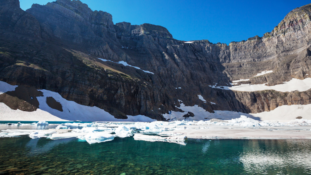 Iceberg Lake surrounded by steep mountain cliffs